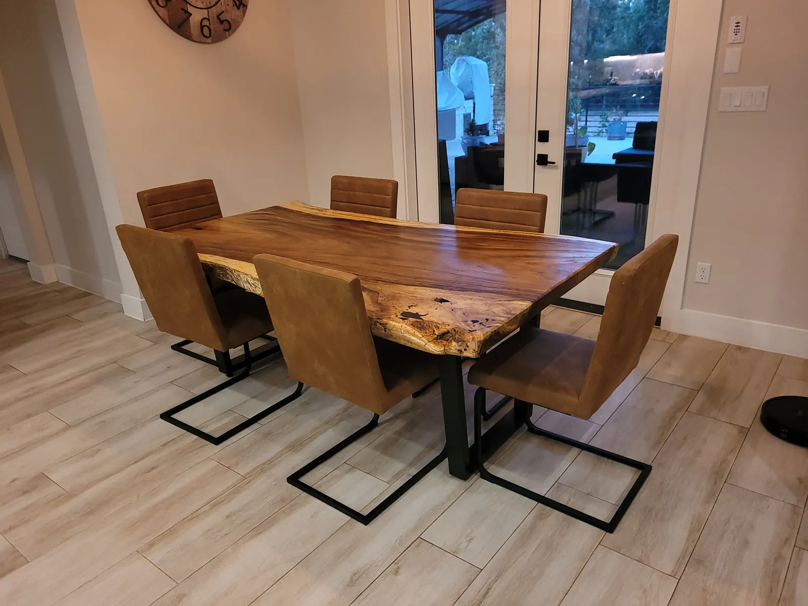 Live edge dining table with cantilever chairs in customer home