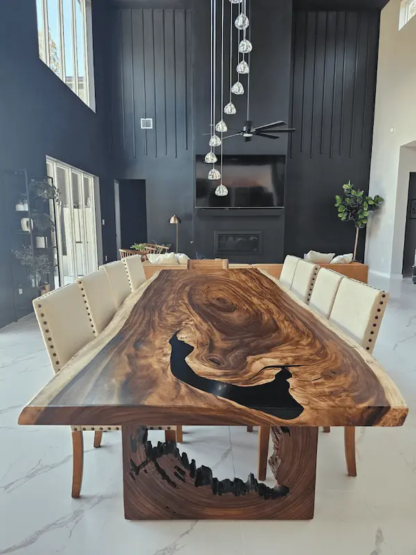 Modern epoxy river dining table made from live edge wood slab.