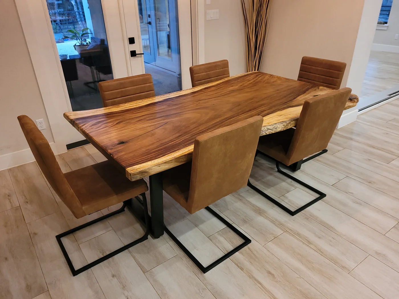 Live edge dining table with seating in a styled dining room