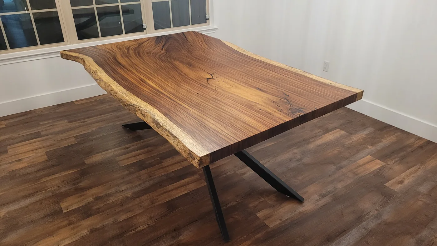 Walnut live edge slab dining table on dark hardwood floor